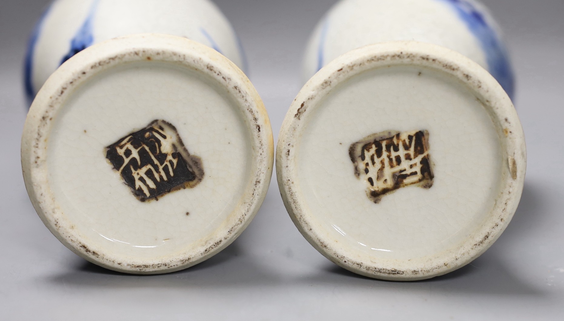 A pair of early 20th century Chinese blue and white crackle glaze vases and covers, 30cm